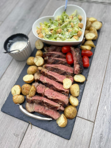 Slow cooked Tomahawk steak, served with a crisp caesar salad, garlic roasted potatoes & homemade aioli