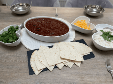Slow cooked indulgent beef chilli served with basmati rice, warm tortillas & cheese